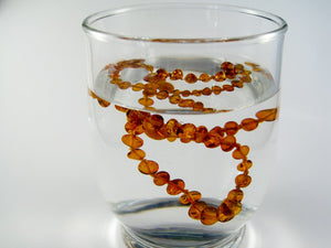 amber teething necklace in salted water, test for original, genuine baltic amber